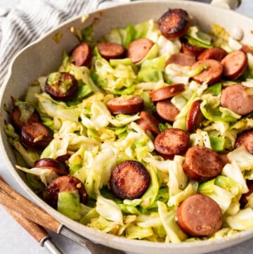 A one-pot cabbage and sausage dinner in a skillet.