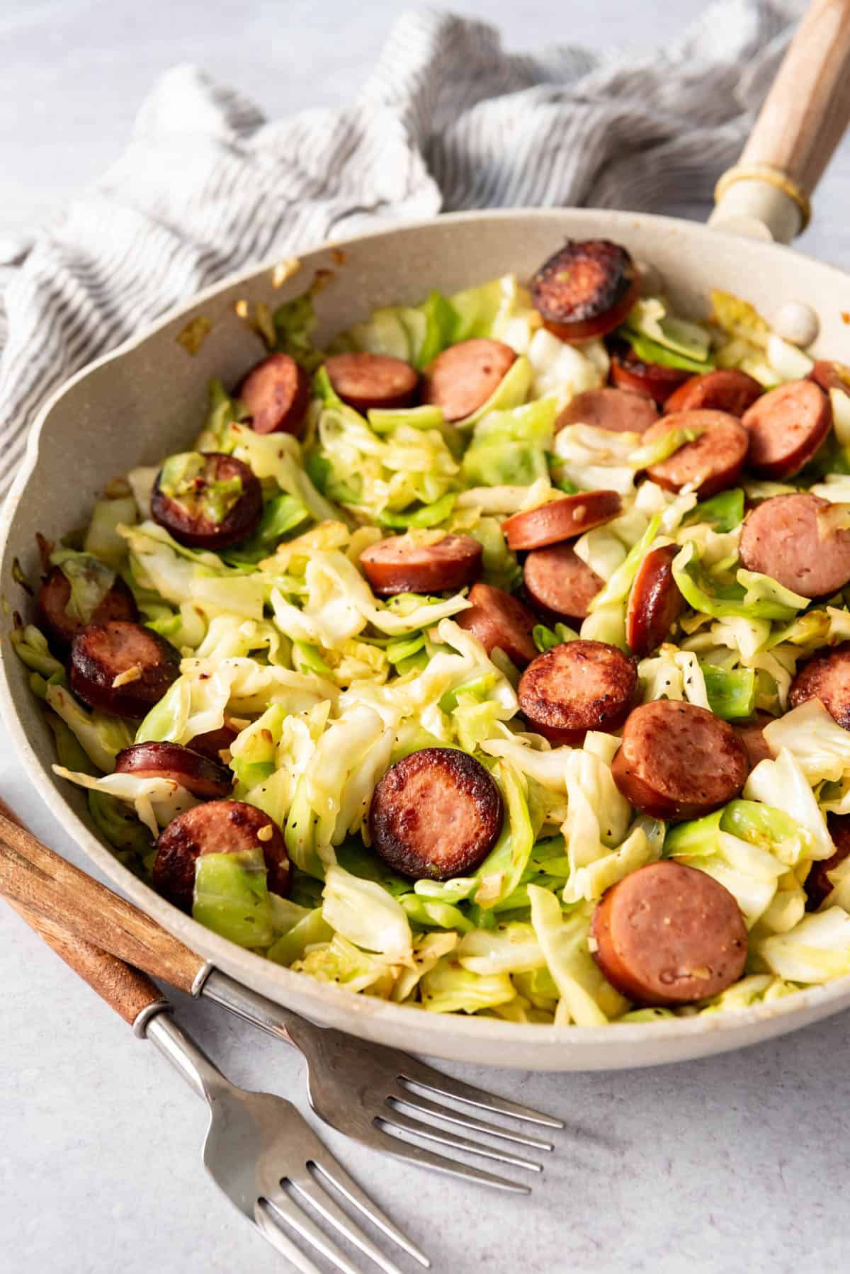 A one-pot cabbage and sausage dinner in a skillet.