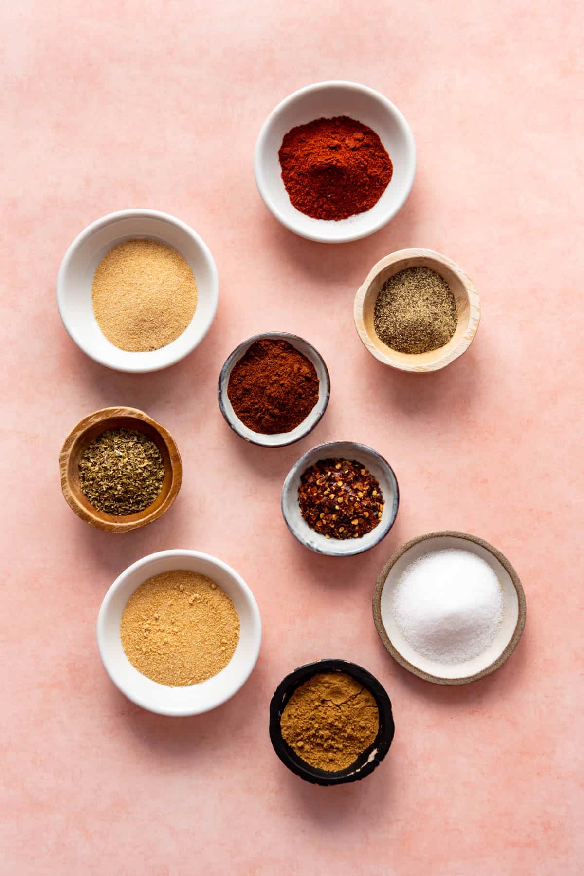 Mexican spices in individual bowls for making homemade taco seasoning.