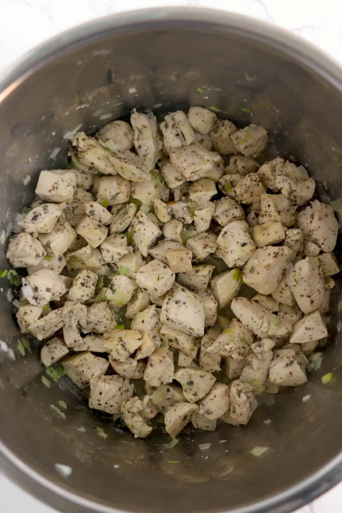 Seared chicken pieces in an Instant Pot.