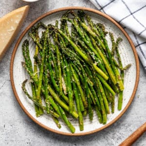 A plate of air fryer asparagus with parmesan and garlic.