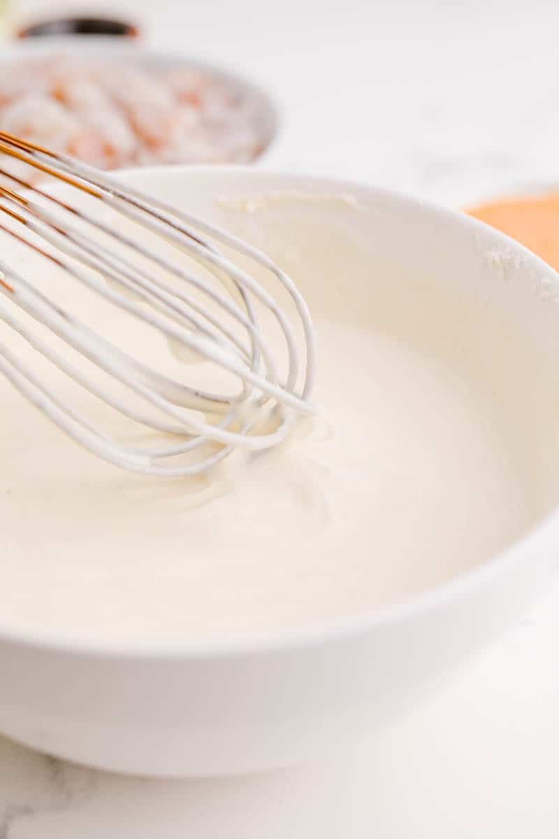 A close-up shot of buttermilk being mixed with flour and cornstarch