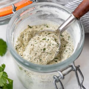 A spoon in a jar of homemade ranch seasoning mix.