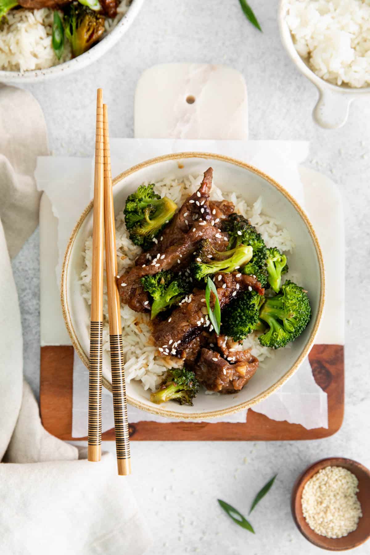 A bowl of instant pot mongolian beef with chopsticks.
