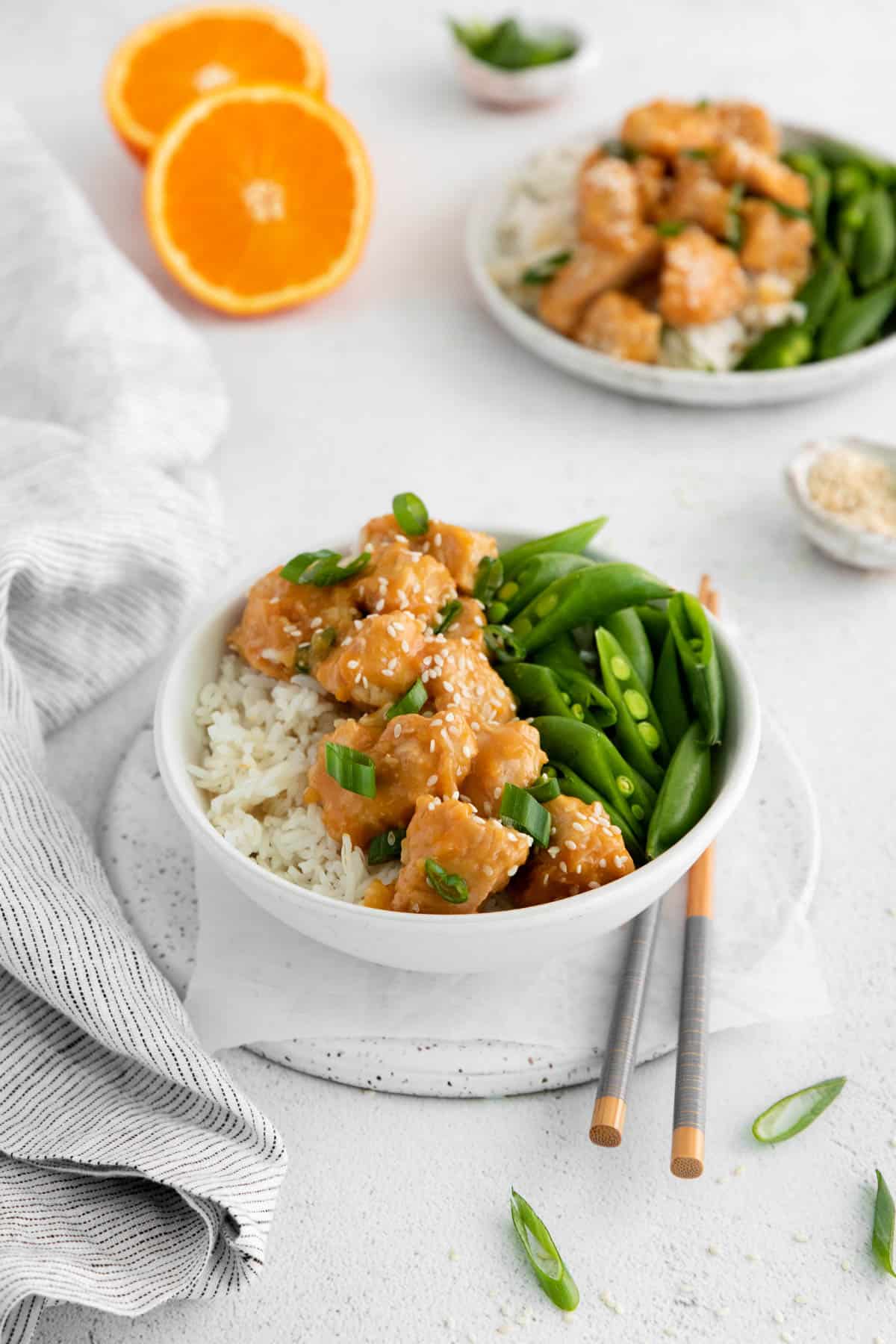 A bowl of instant pot orange chicken with vegetables and rice.