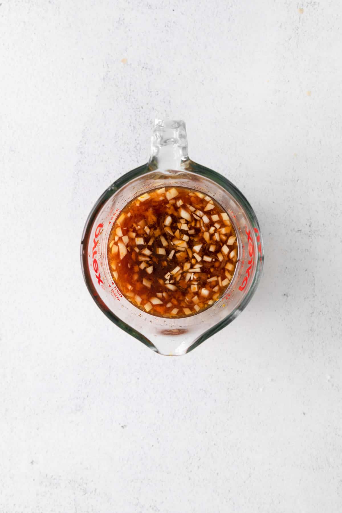 Orange chicken sauce in a glass bowl.