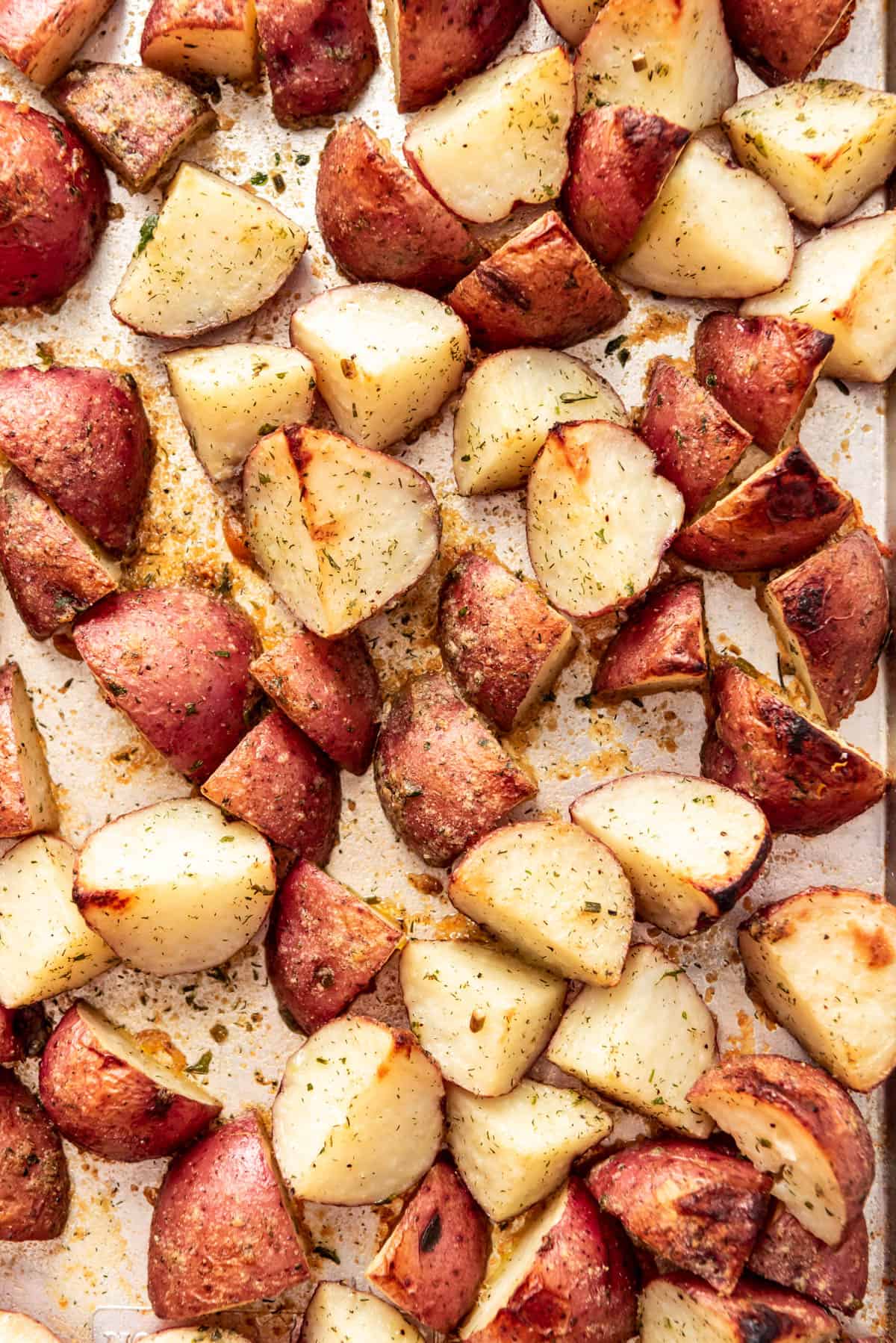 A close image of roasted ranch potatoes on a baking sheet.