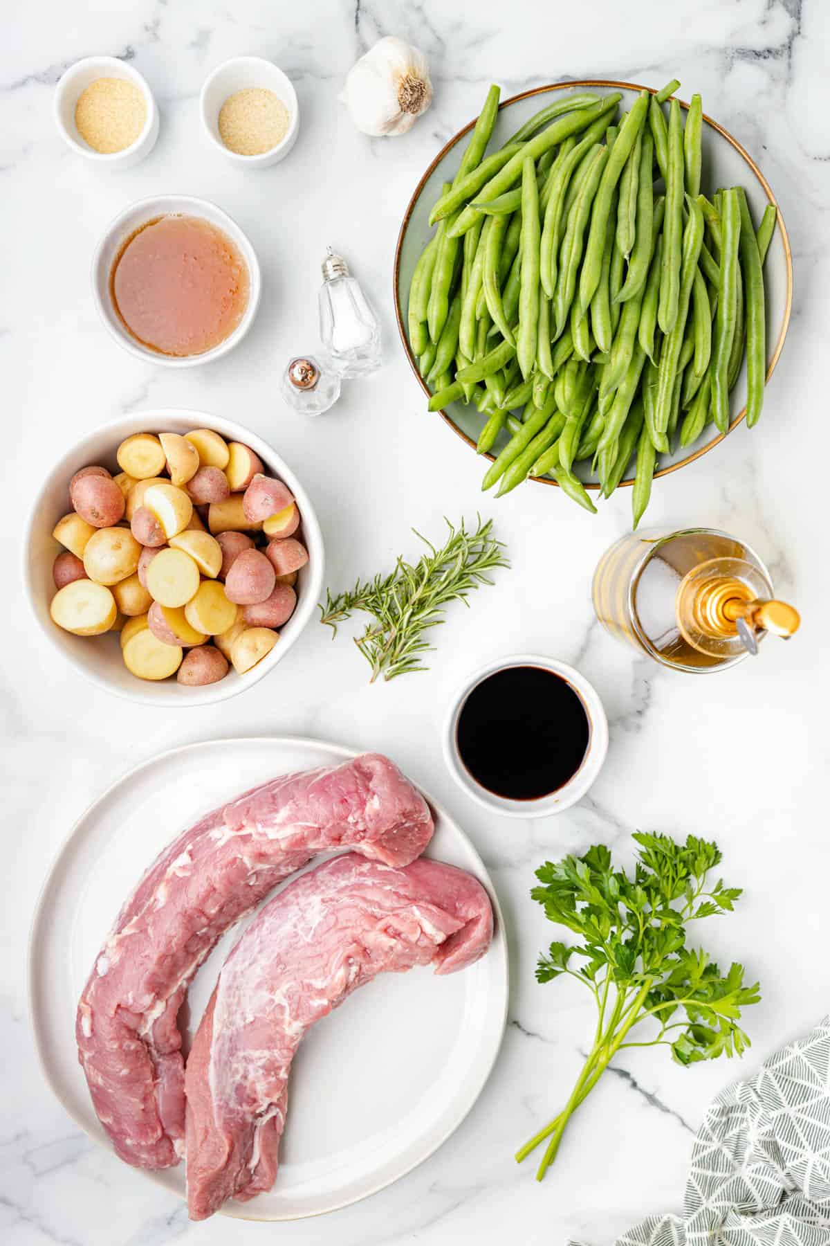 Ingredients for sheet pan pork tenderloin with potatoes and vegetables.