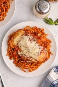 An overhead image of a plate of chicken parmesan made in a crockpot.