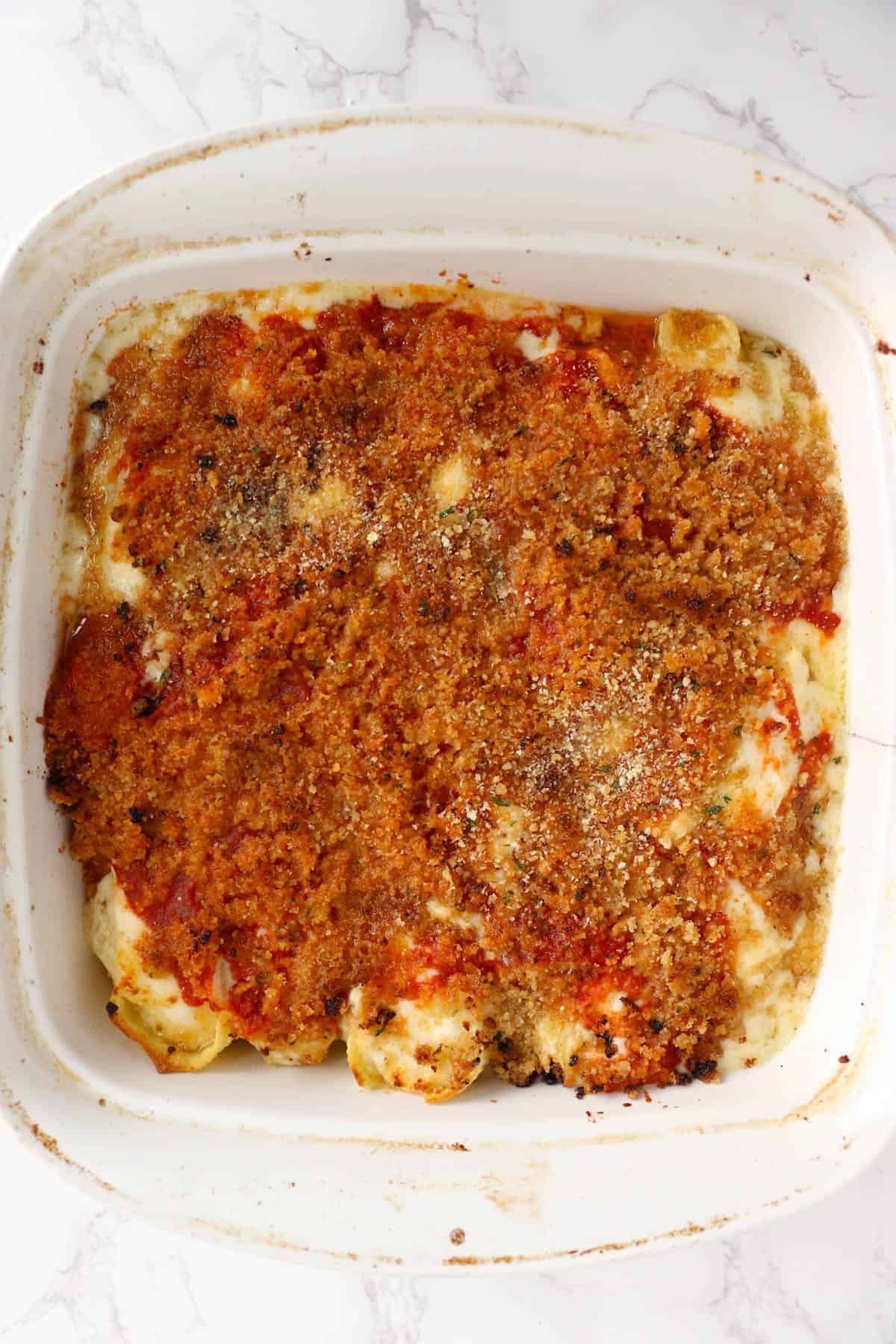 Baked Olive Garden Stuffed Shells in a white casserole dish.