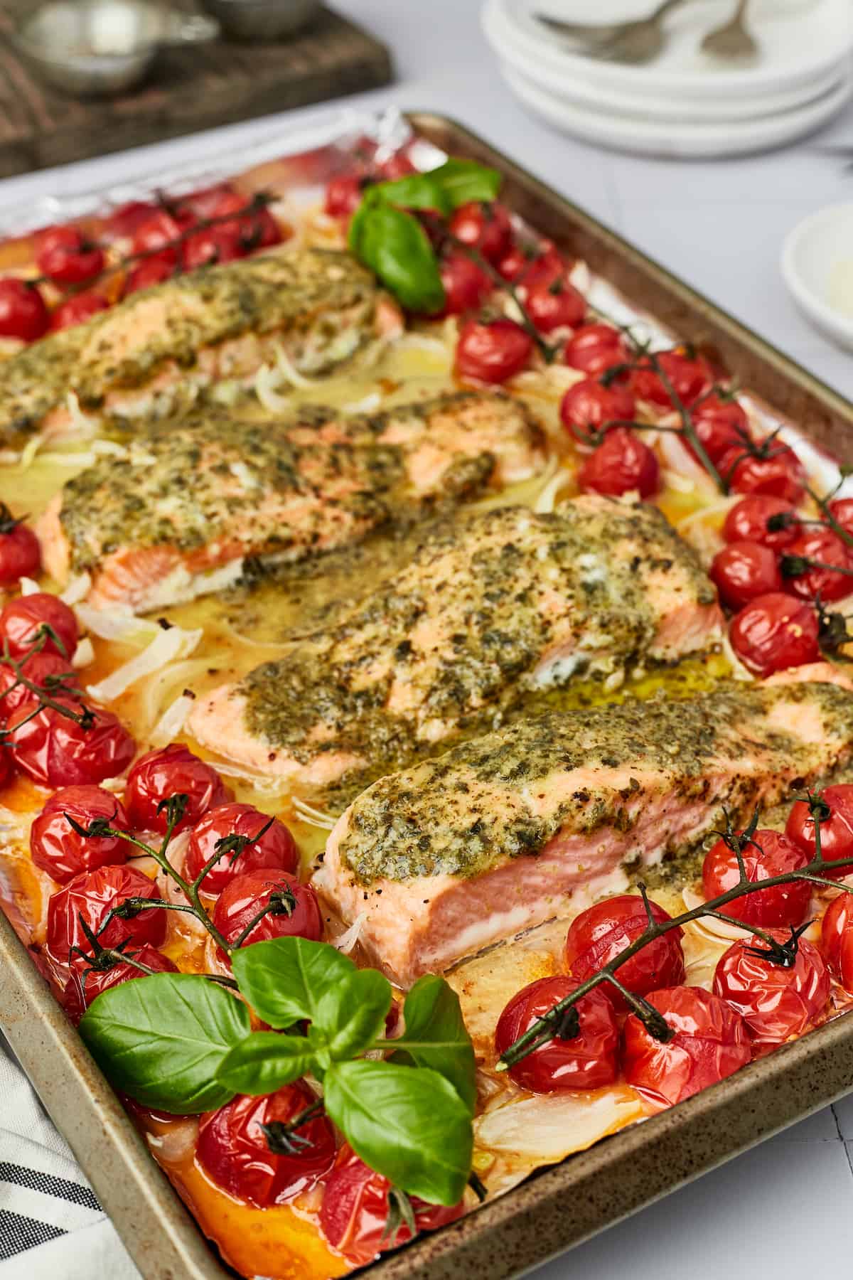 t pesto salmon on sheet pan with cherry tomatoes and basil