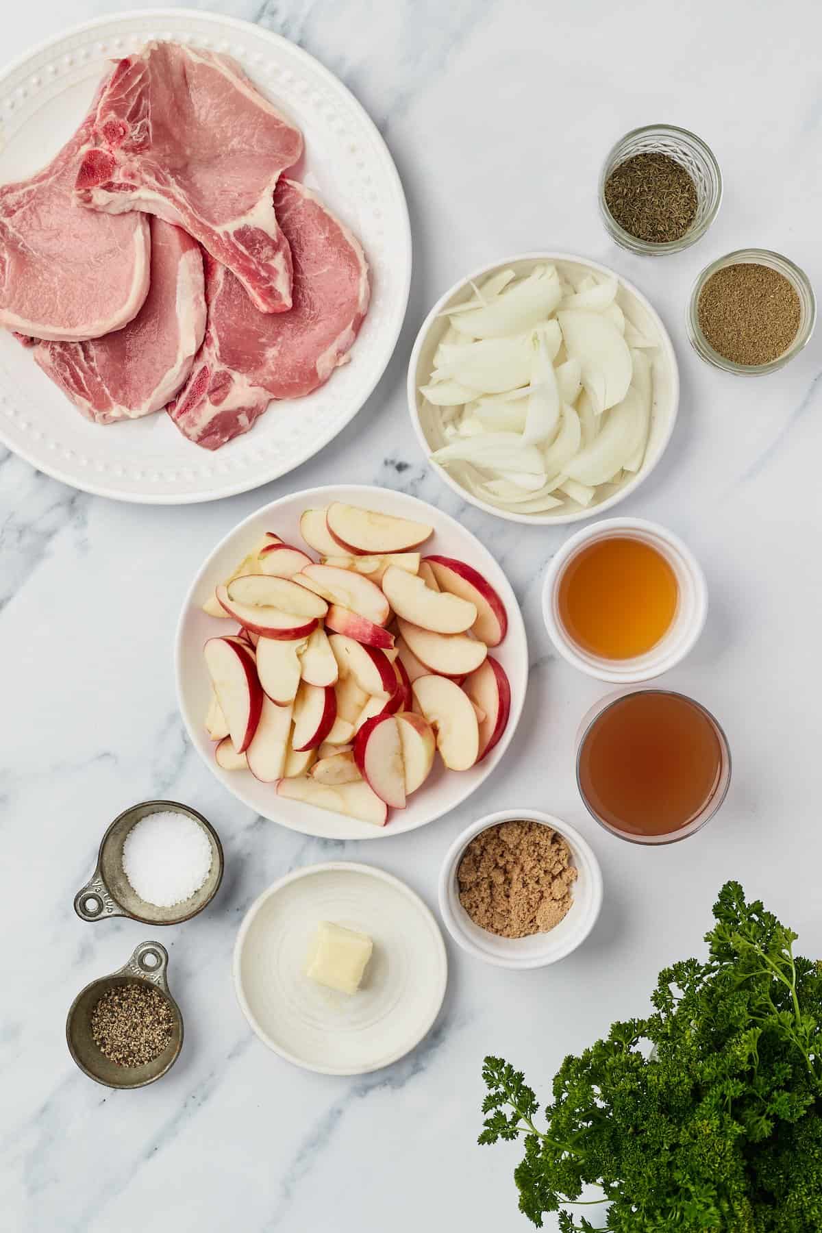 Overhead view of ingredients for pork chops with apples and onions
