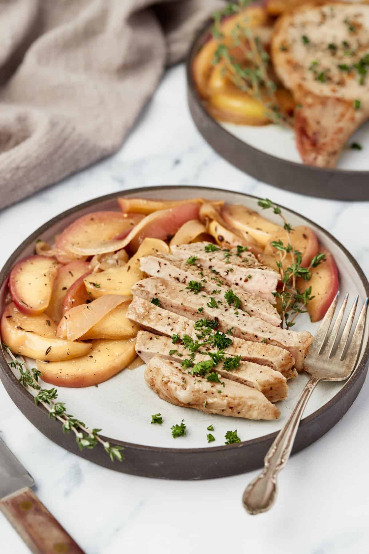 Plate of pork chops with apples and onions