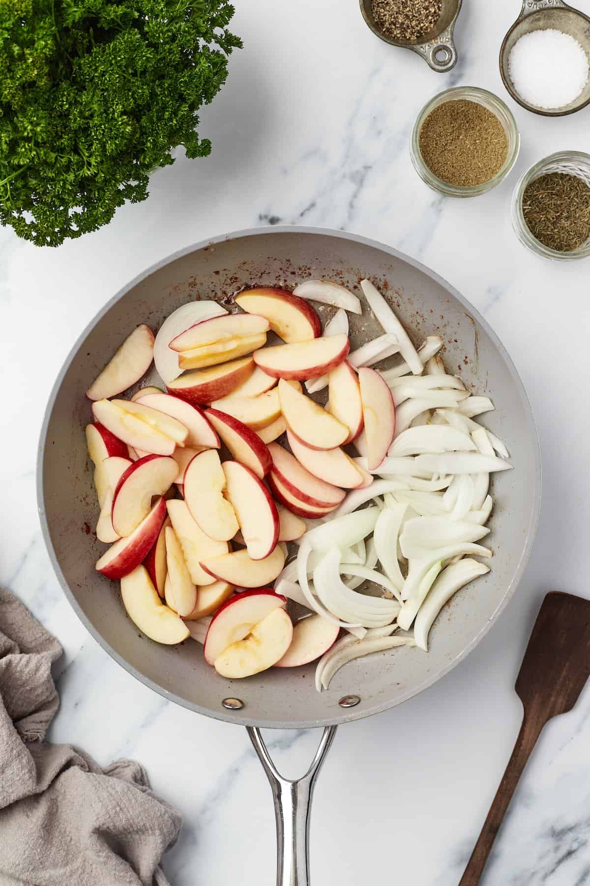 Apples and onions in skillet, before cooking