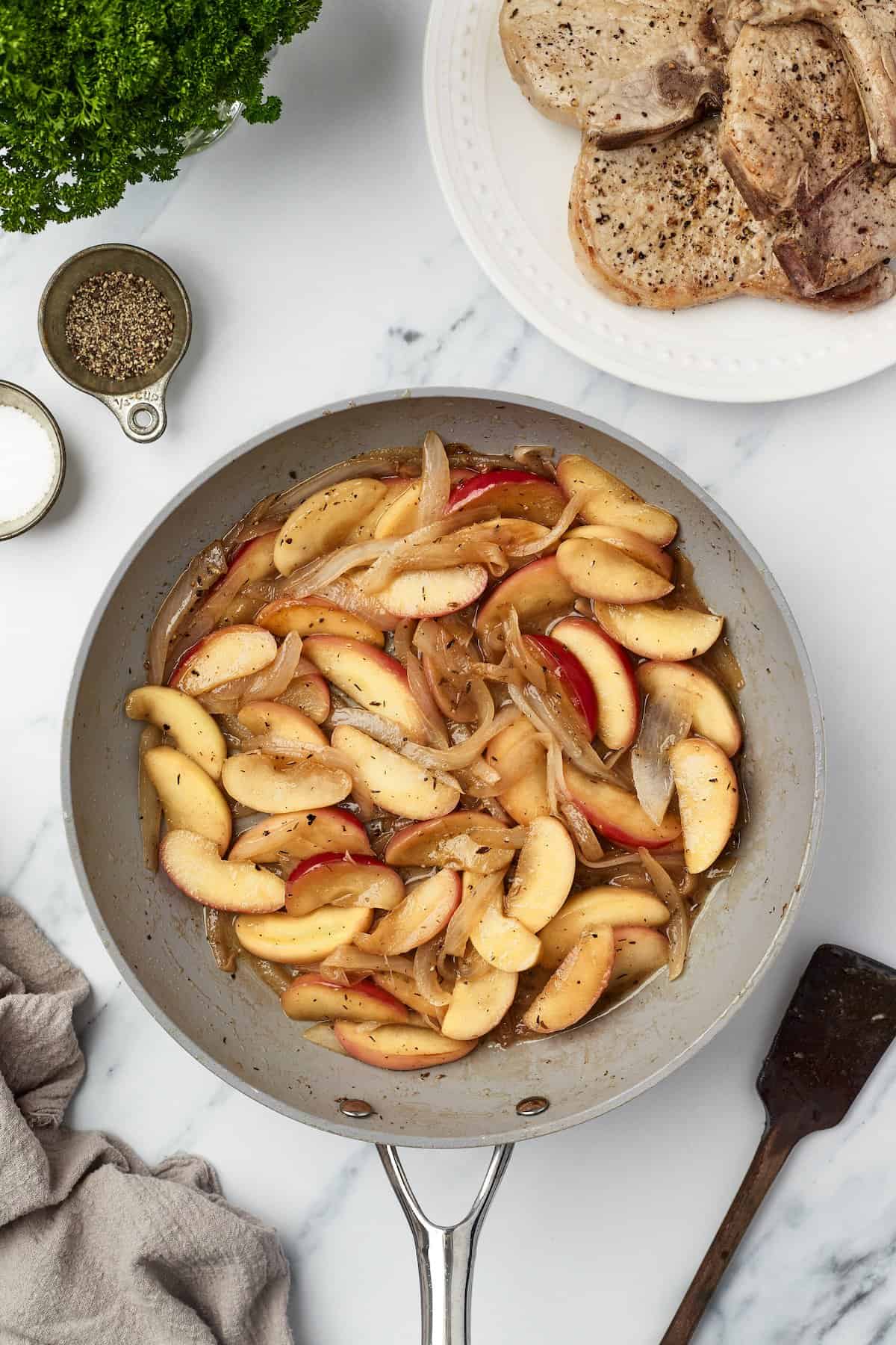 Overhead view of apples and onions in skillet