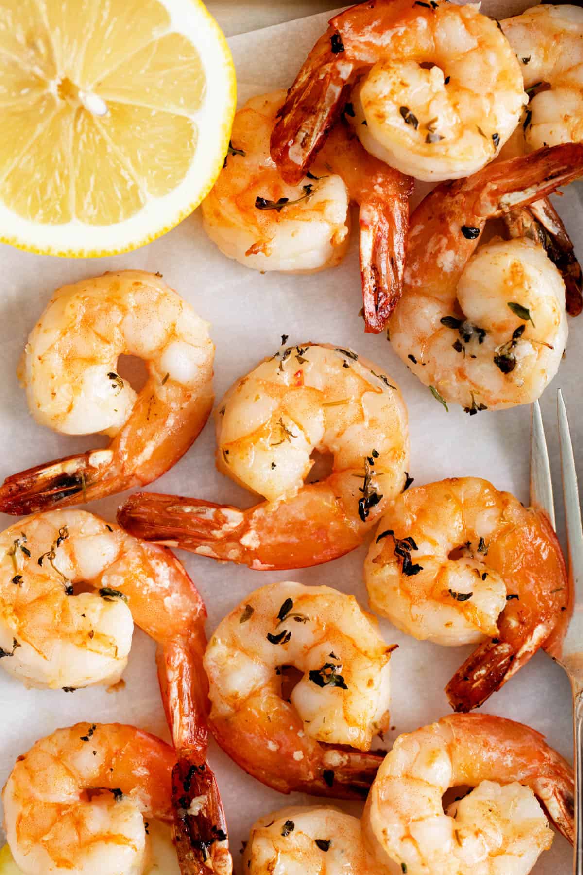 A close image of air fryer shrimp with garlic herb butter.