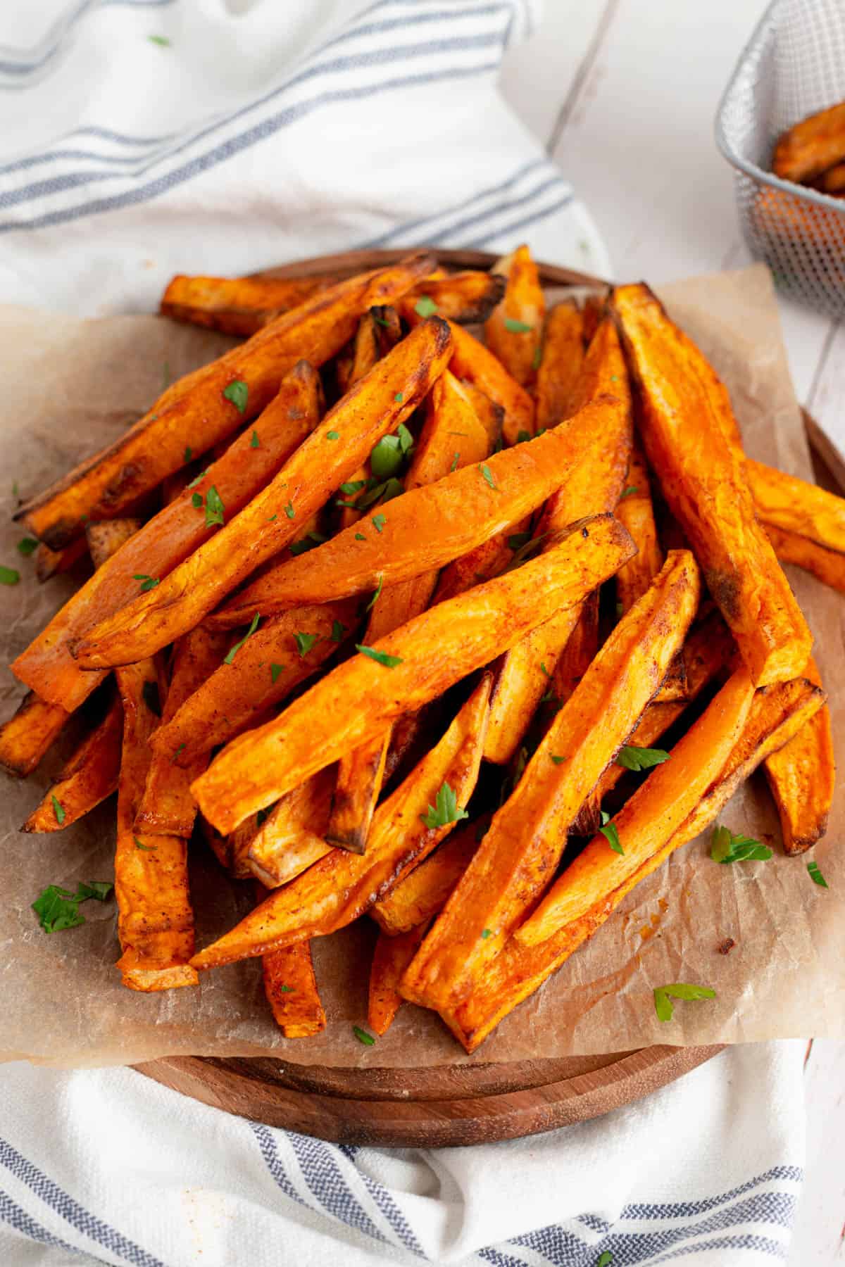 Close up shot of a plate of cooked sweet potato fries. 