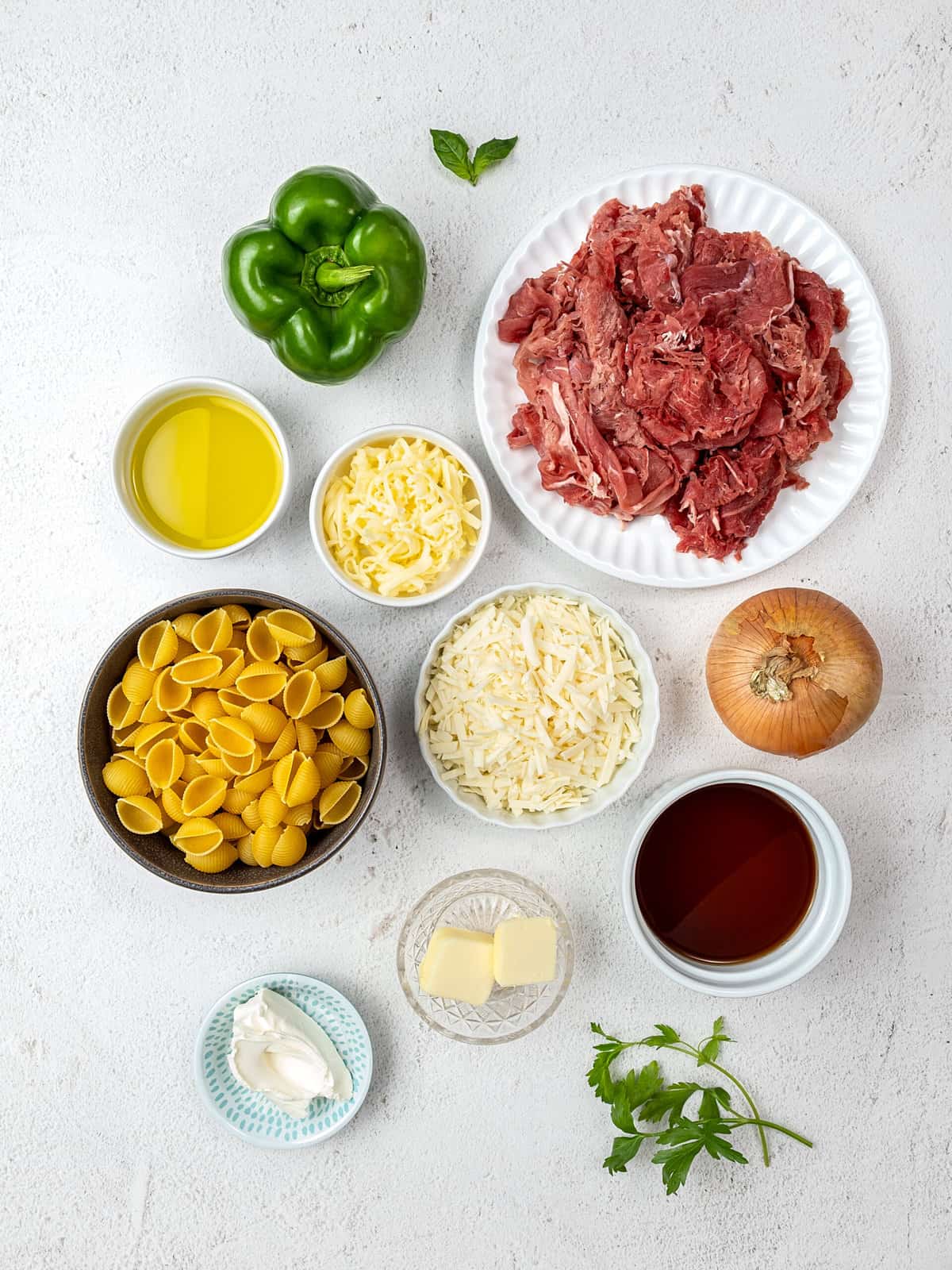 Overhead view of ingredients for Philly cheesesteak pasta