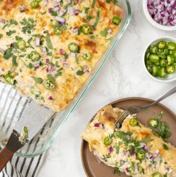 Overhead view of chicken enchiladas on plate and in casserole dish
