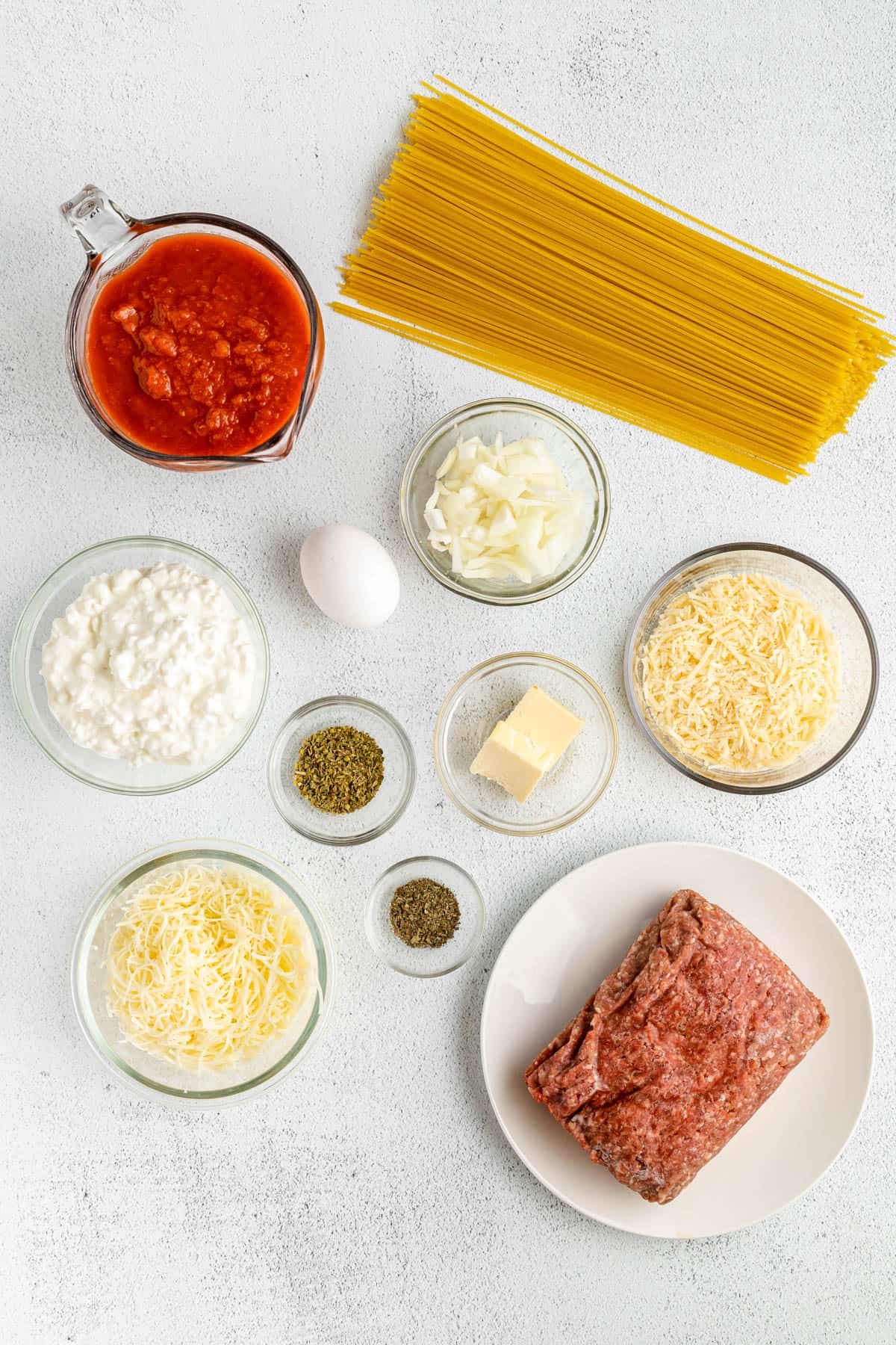 Spaghetti pie ingredients in separate bowls.
