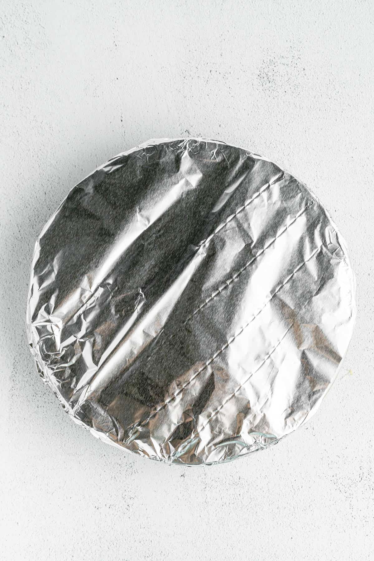 Foil covering spaghetti pie before baking.