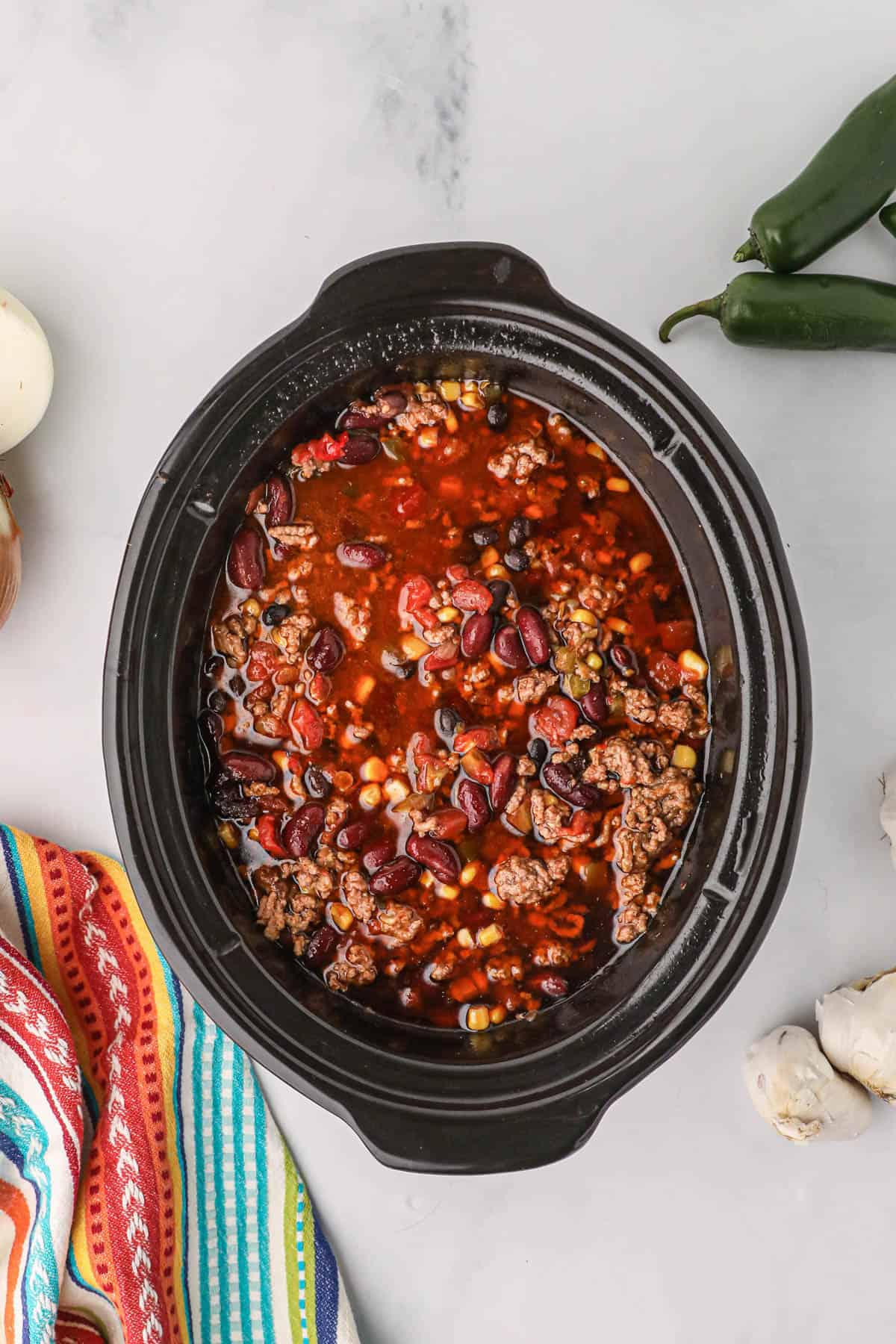 Mixed taco soup ingredients in a slow cooker.