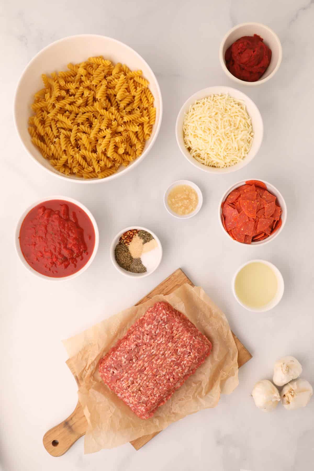 Ingredients for making pizza pasta casserole.