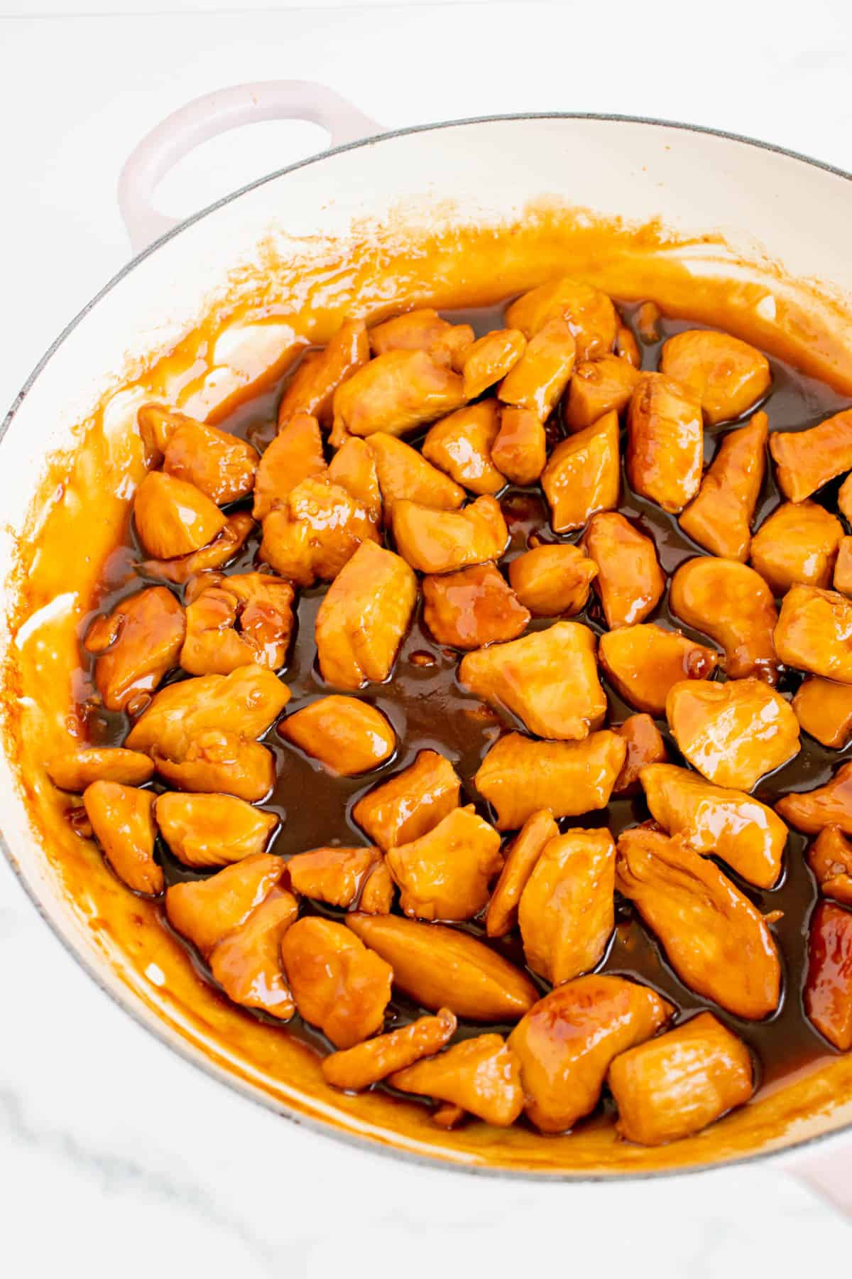 Bite size pieces of chicken breast are cooked in a brown teriyaki sauce