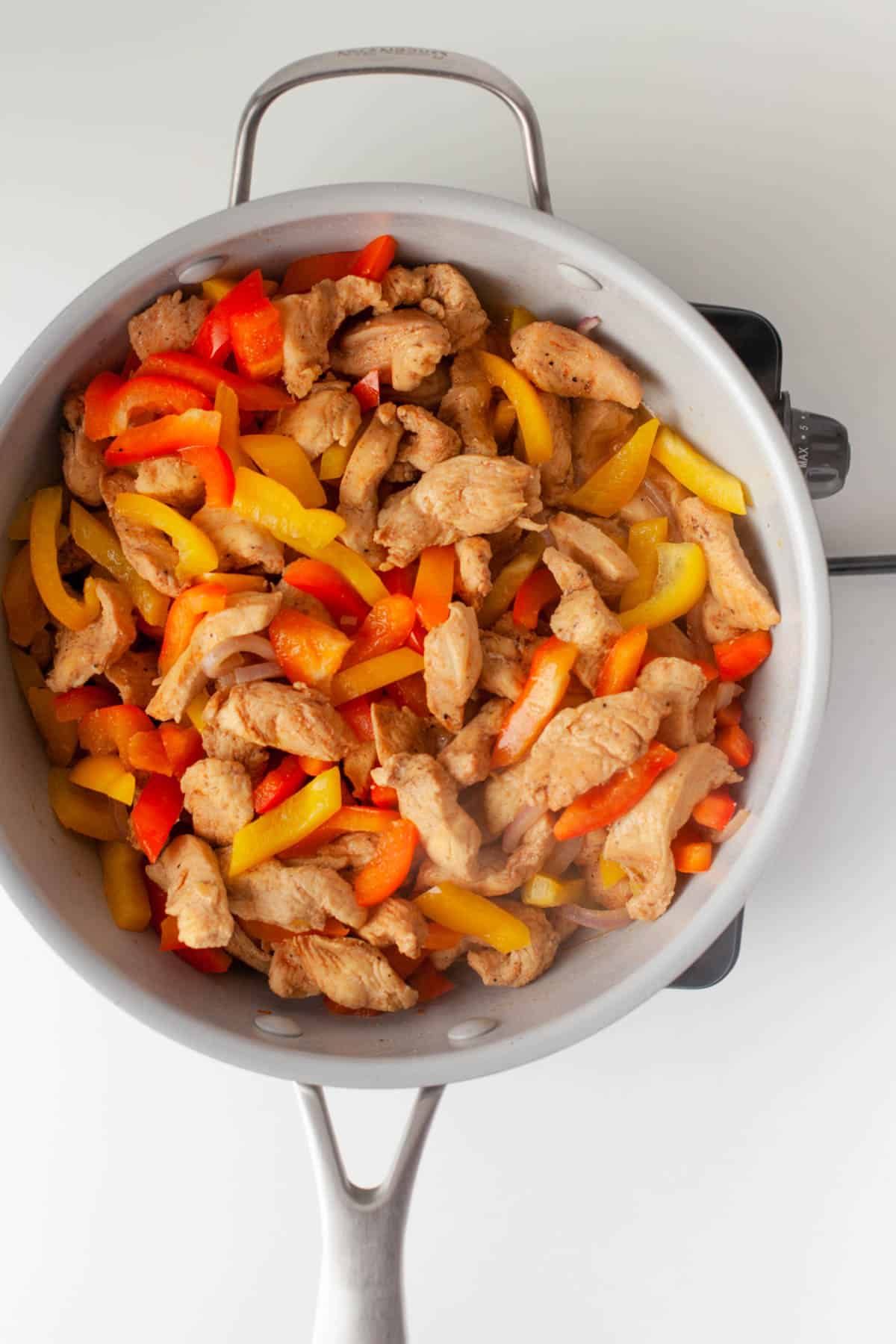 Finished chicken fajitas in a skillet.
