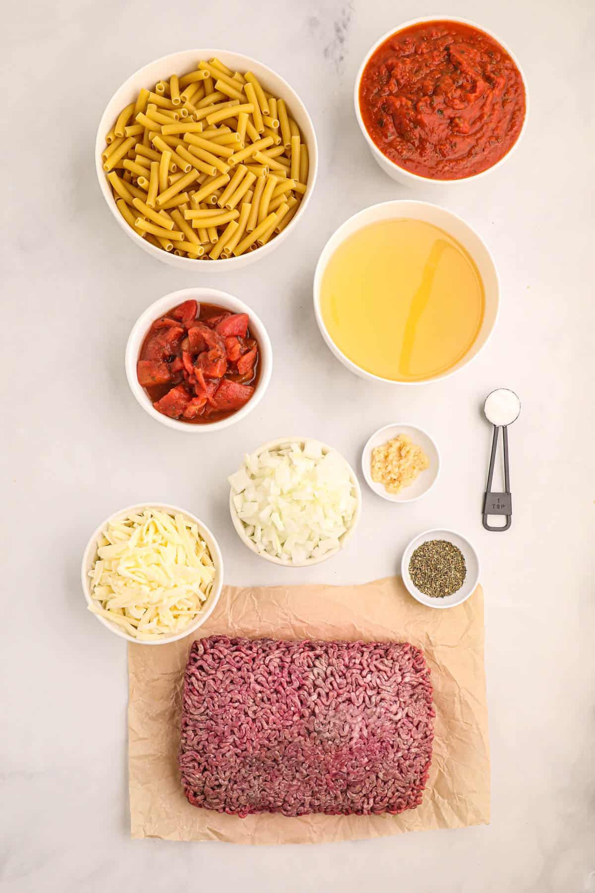 Ingredients for crock pot baked ziti in individual bowls.