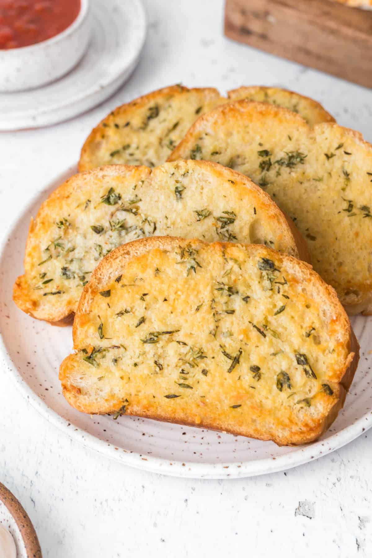Slices of garlic bread on a plate.