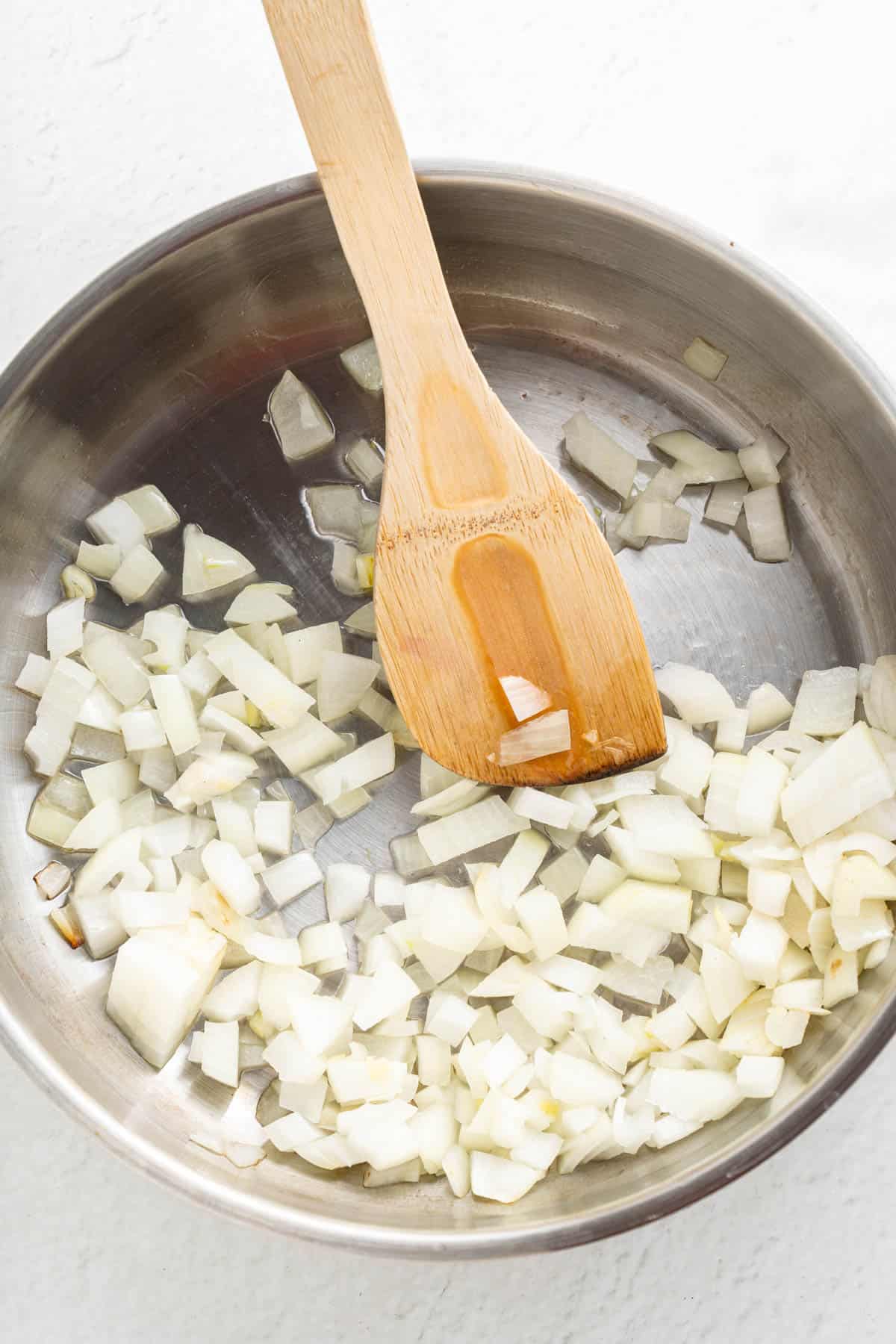 Sauteeing chopped onions in a pan.