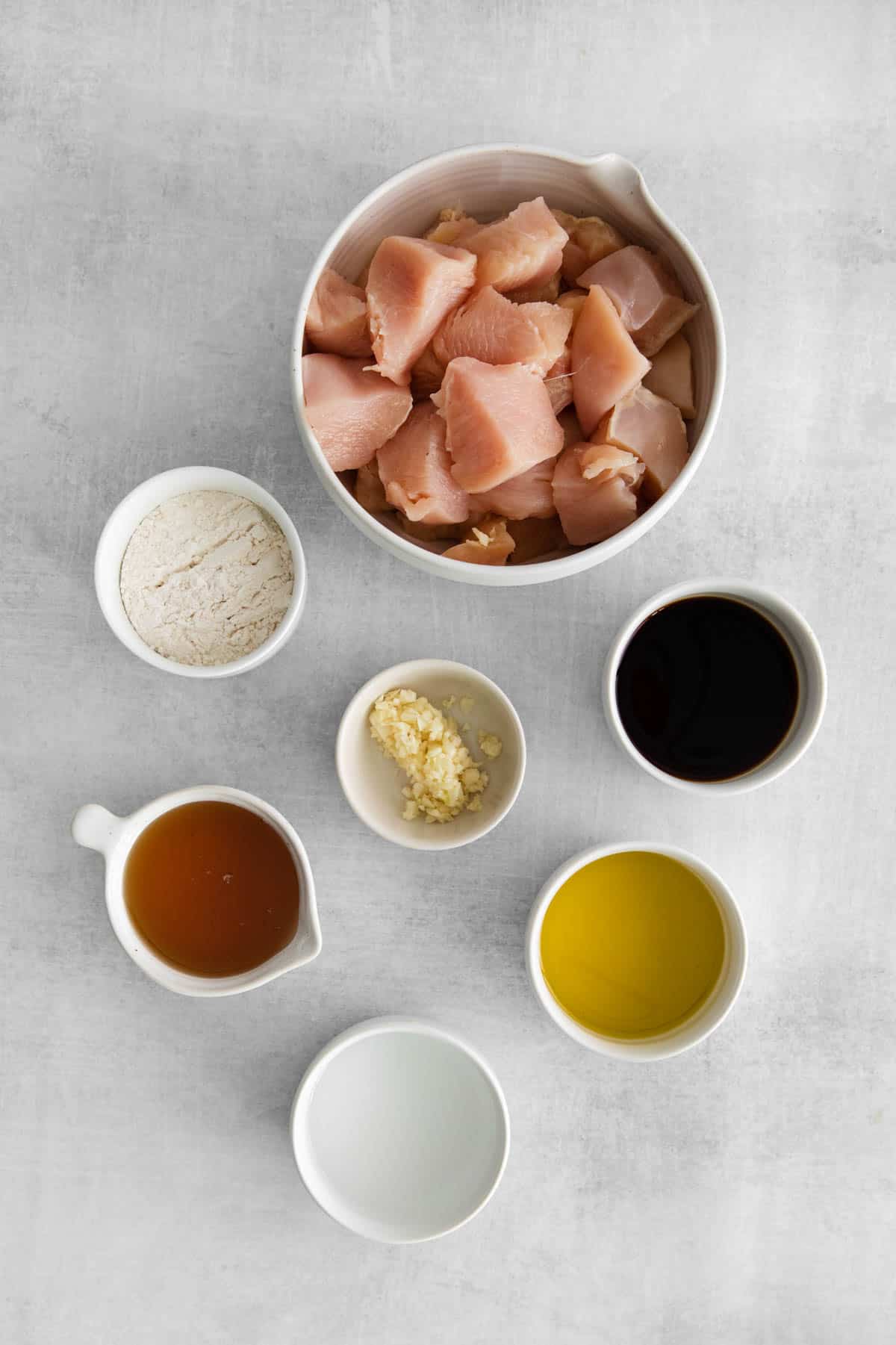 Ingredients for honey garlic chicken bowls in individual bowls.
