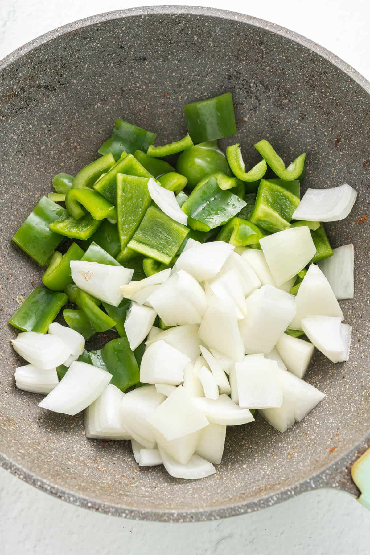 Chopped onion and green pepper in a large pan.