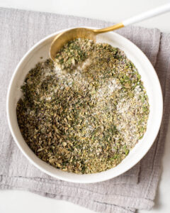 An image of a bowl of mixed herbs for making homemade Greek seasoning.