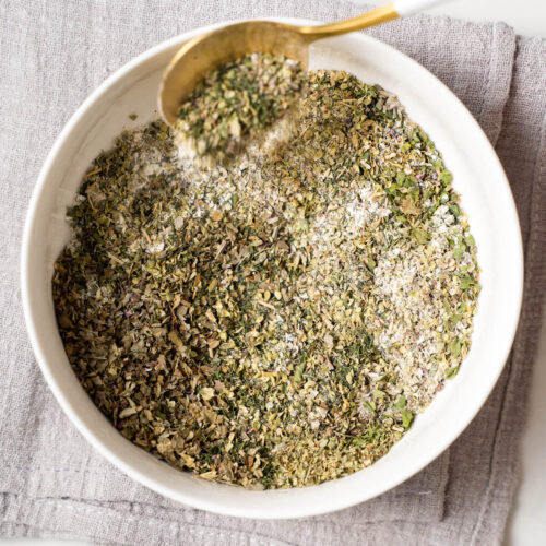 An image of a bowl of mixed herbs for making homemade Greek seasoning.