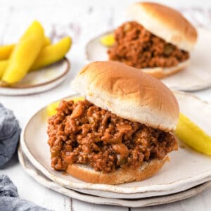 Sloppy Joes on hamburger buns with dill pickle spears.