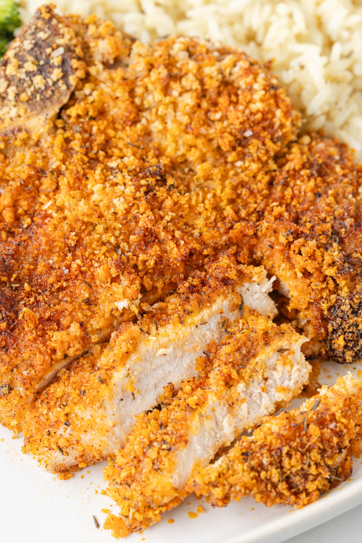 Close up of cooked pork chop with several pieces sliced. 