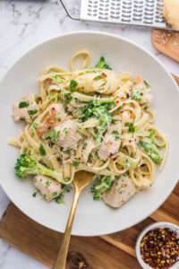 An overhead image of a plate of chicken and broccoli fettuccine alfredo.