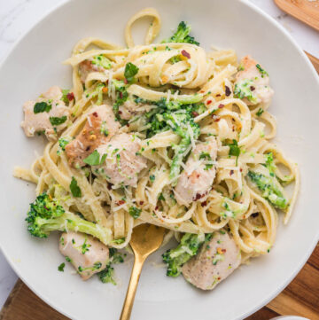 An overhead image of a plate of chicken and broccoli fettuccine alfredo.