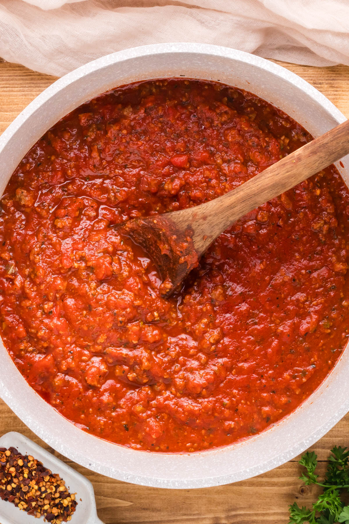 A close up image of meat sauce with a spoon in it.