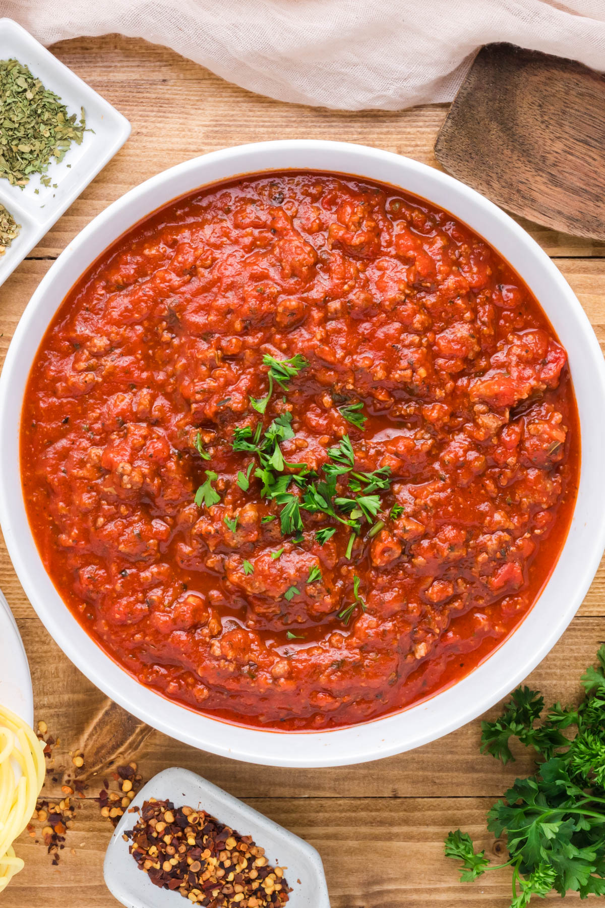 An overhead image of homemade meat sauce in a large serving bowl.