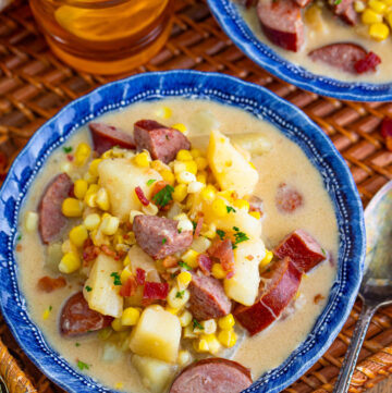 Kielbasa corn chowder is served in a blue soup bowl.